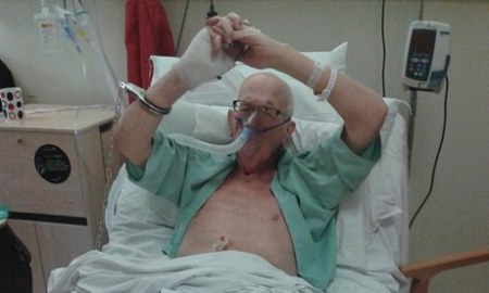 Michael Tyrrell handcuffed to his hospital bed the day before he died. His daughter took the photo